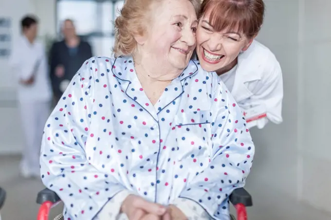 Doctor caring for elderly patient in wheelchair