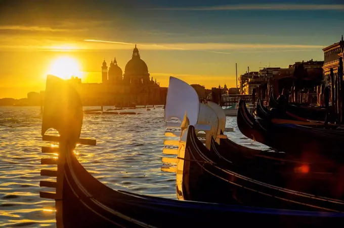 Italy, Veneto, Venice, Gondolas at sunset, Santa Maria della Salute in the background