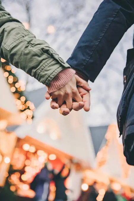 Close-up of couple holding hands on the Christmas Market