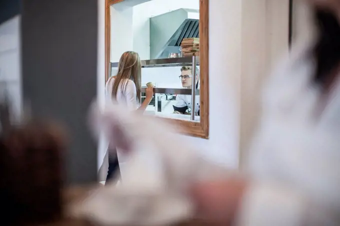 Waitress picking up food from the kitchen