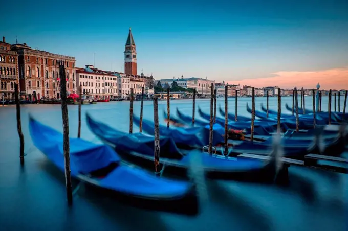 Italy, Venice, moored gondolas at morning twilight