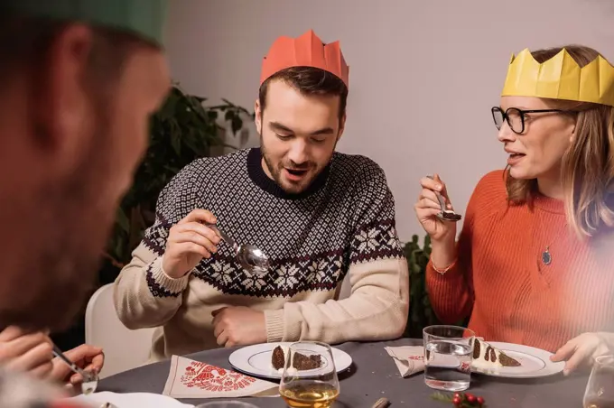 Family members talking while having Christmas pudding