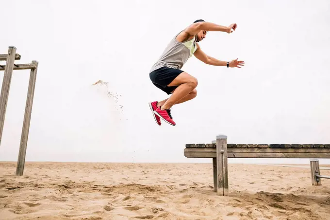 Young man jumping on the beach