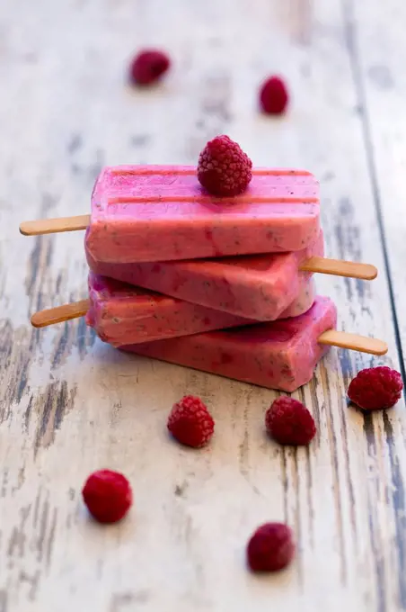 Stack of homemade raspberry ice lollies