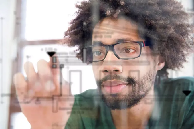 Young man using transparent touchscreen display