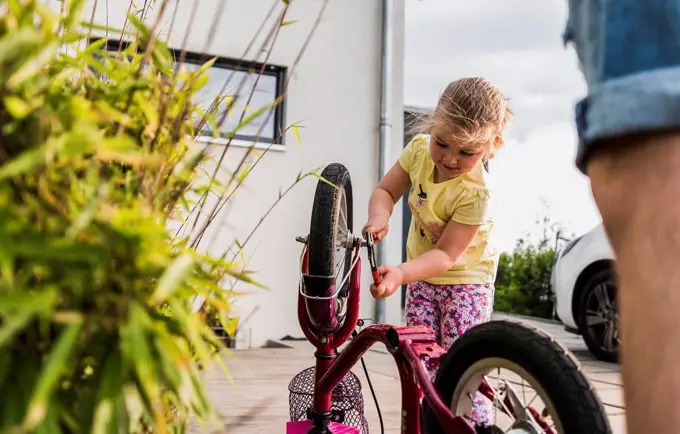 Girl repairing bicycle