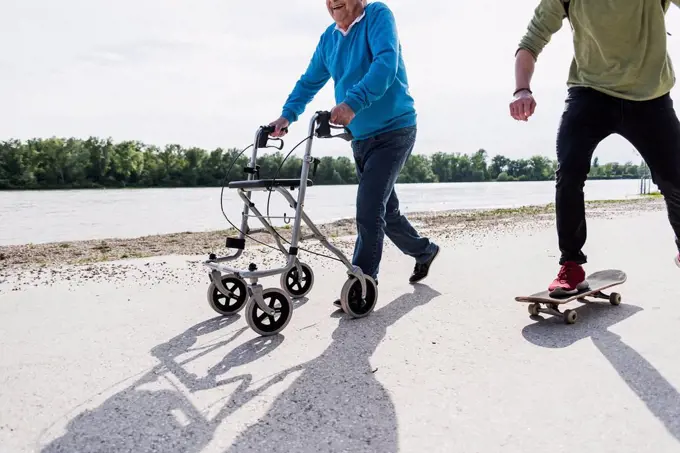 Grandfather and grandson having fun together at riverside