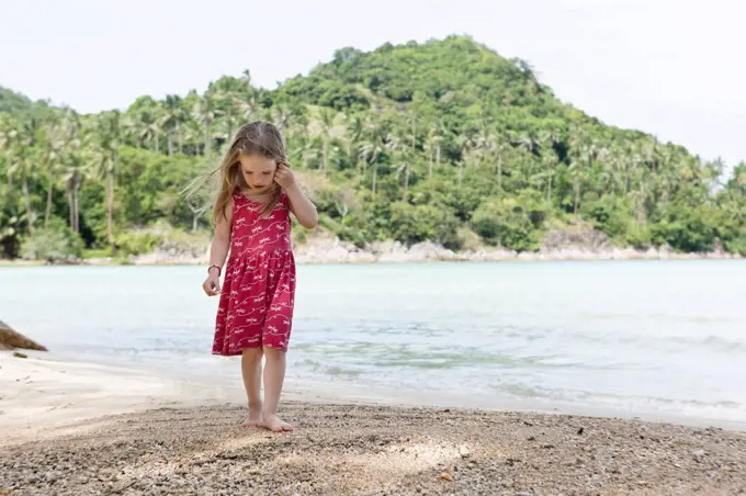 Thailand, girl in red dress on beach