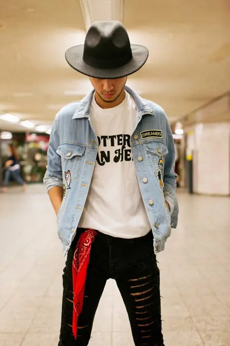 Fashionable young man wearing hat and jeans jacket