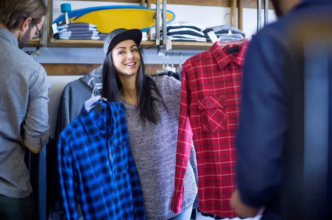 Friends choosing clothes in shop