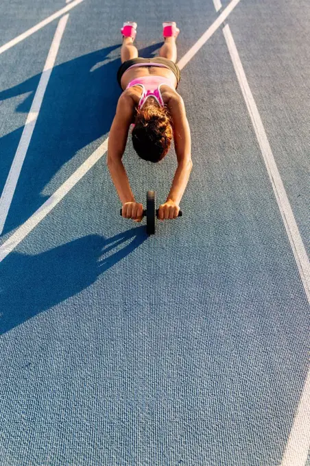 Female athlete doing strength training with a roller