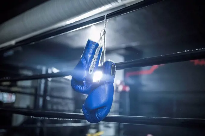 Boxing gloves hanging in boxing ring