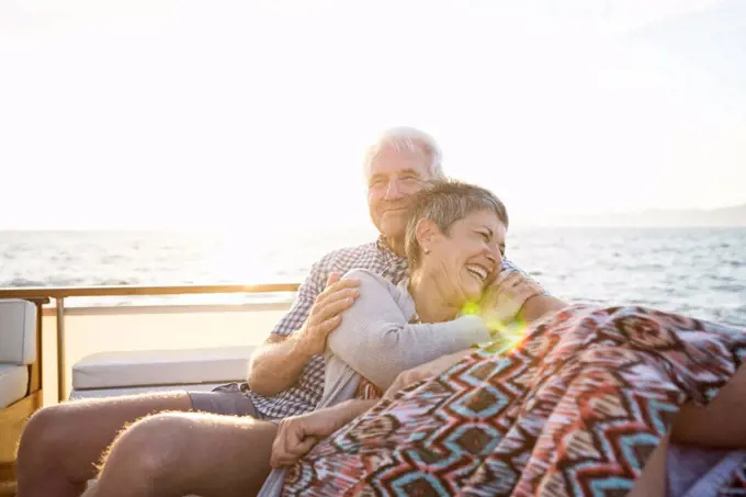 Affectionate couple on a boat trip at sunset