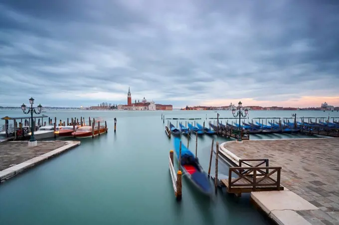 Italy, Venice, moored gondolas at twilight