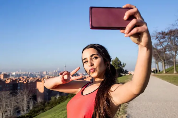 Female athlete posing for a selfie with her phone