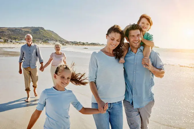 South Africa, Cape Town, three generations family strolling on the beach