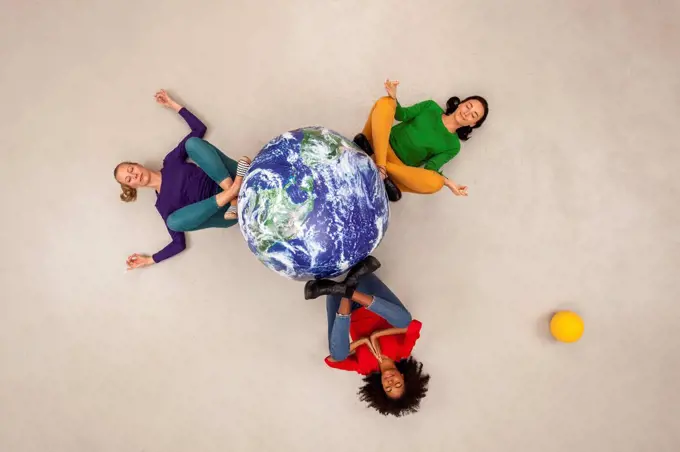 Three women meditating for the world