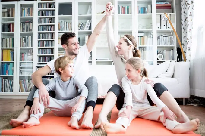 Happy family doing gymnastics at home