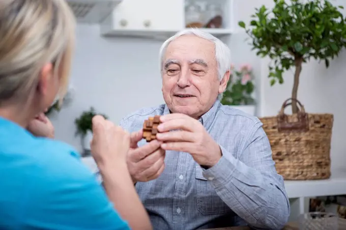 Gereatric nurse doing dexterity games with elderly patient