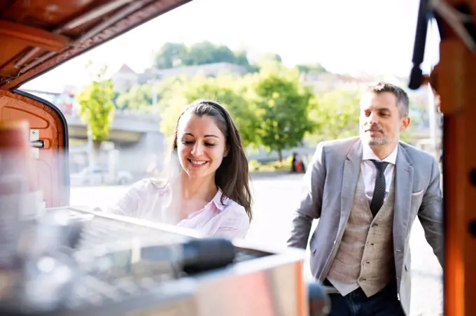 Businessman buying take away coffee on the street