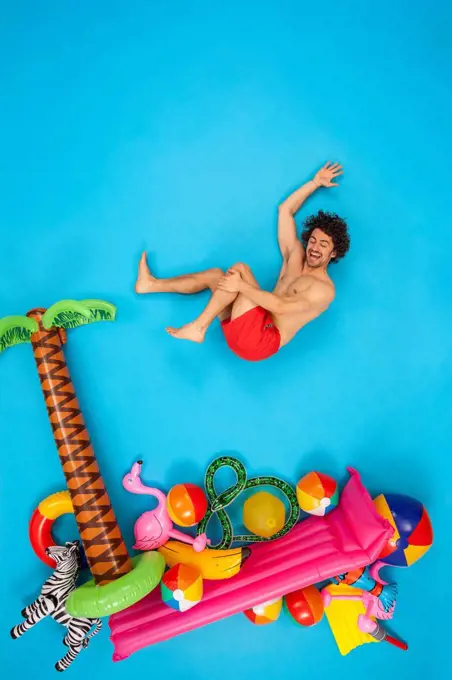 Happy man jumping into the sea