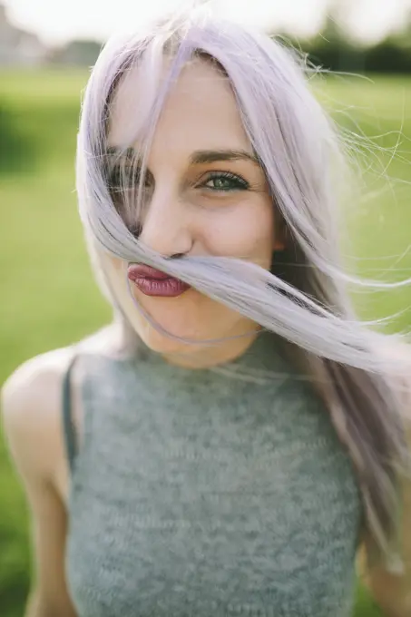 Portrait of young woman pulling funny face