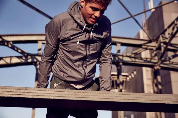 Germany, Munich, Young man training on a bridge