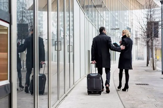 Businessman and businesswoman walking in the city