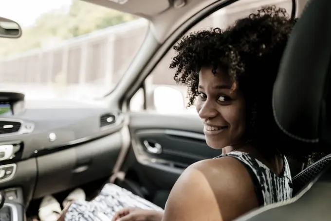 Portrait of smiling young woman in car