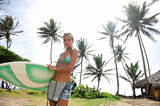 Woman at the coast with surfboard