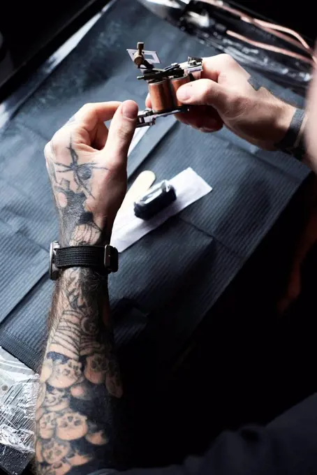 Tattoo artist at work in studio