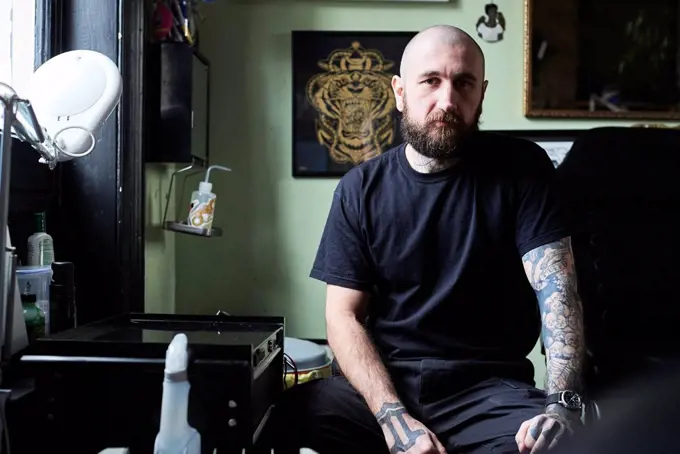 Portrait of tattoo artist in studio