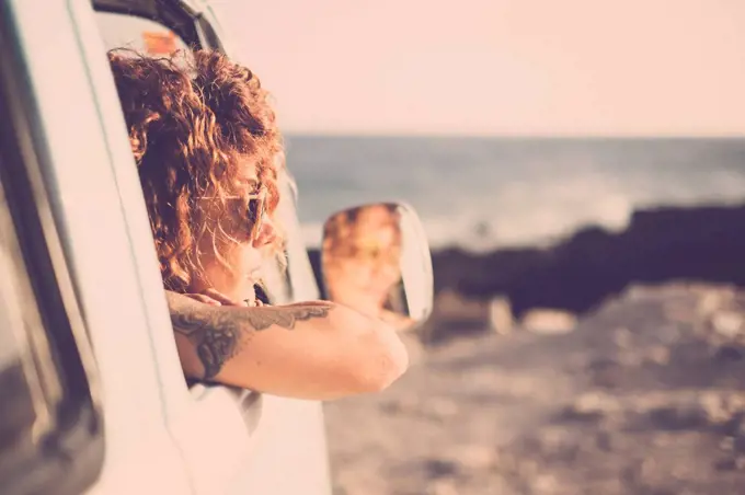 Tatooed woman looking out of a car