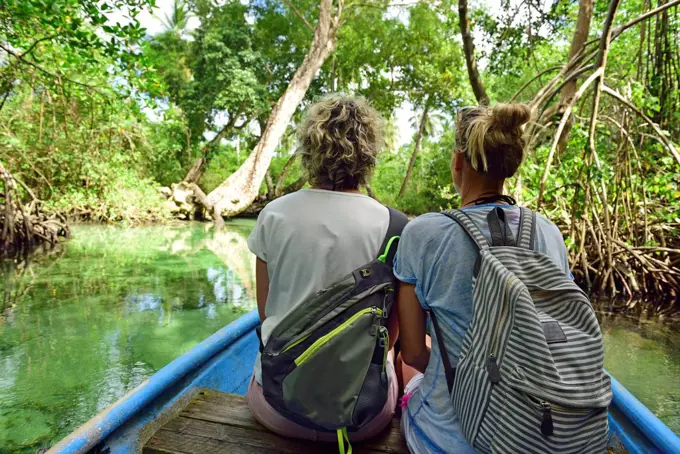 Dominican Republic, Samana, two women in a boat in mangrove lagoon