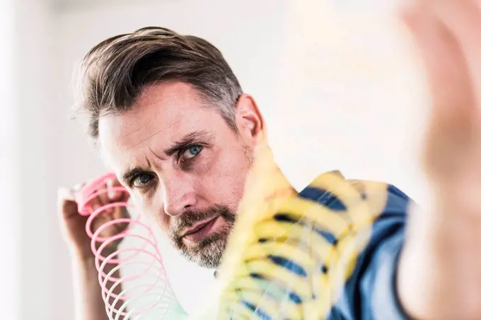 Businessman examining slinky toy