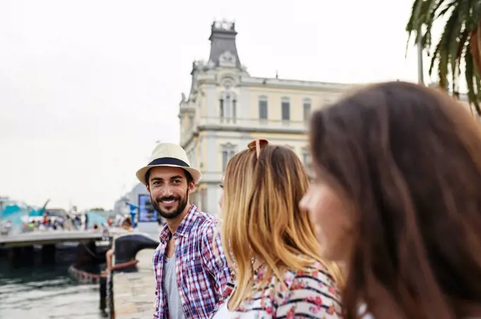 Spain, Barcelona, three tourists at a pier in the city