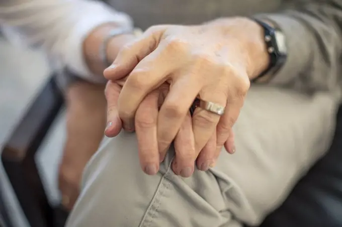 Close-up of senior couple holding hands