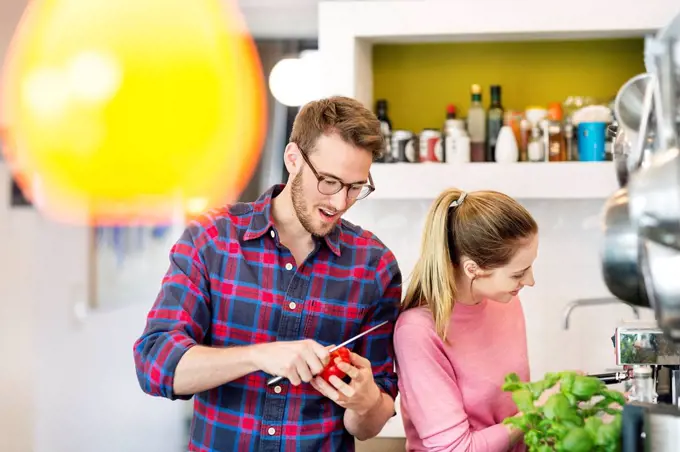 Young couple preparing healthy meal in kitchen