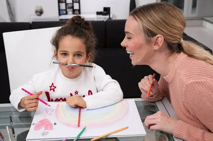 Mother and little daughter having fun at home