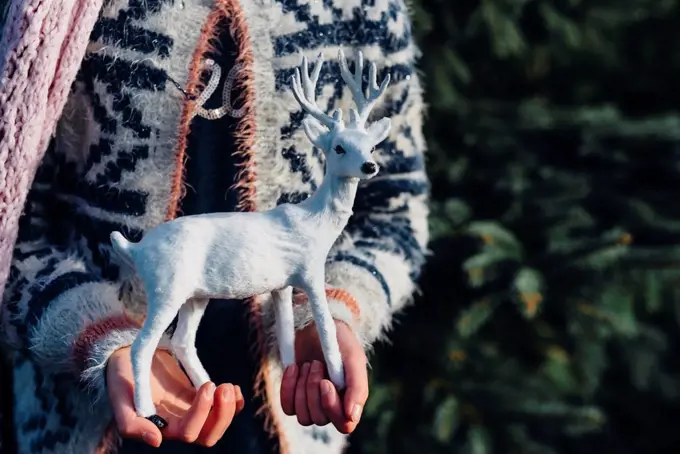 Little girl holding toy reindeer