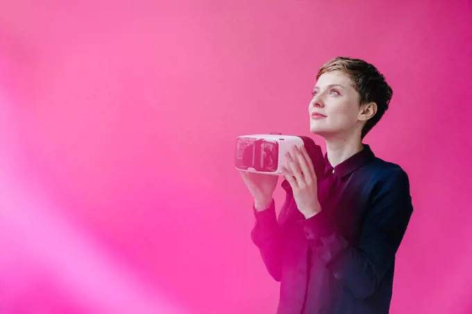 Woman holding VR glasses