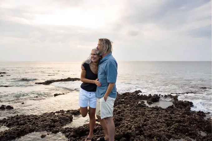 Affectionate senior couple embracing at the sea