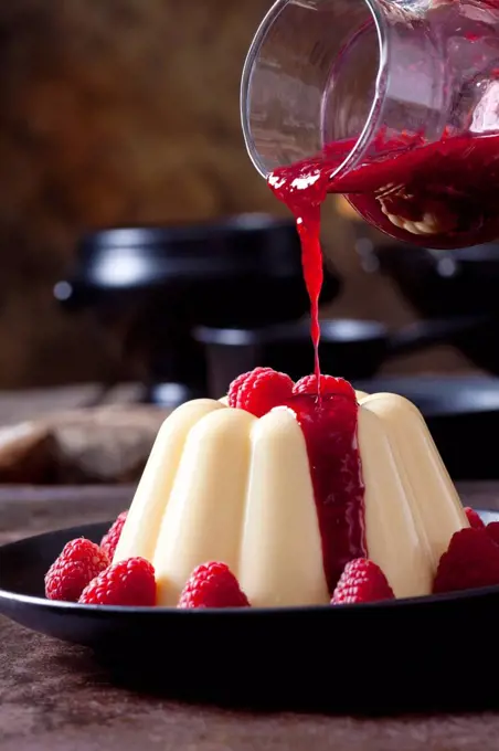 Custard with raspberries and raspberry sauce on plate