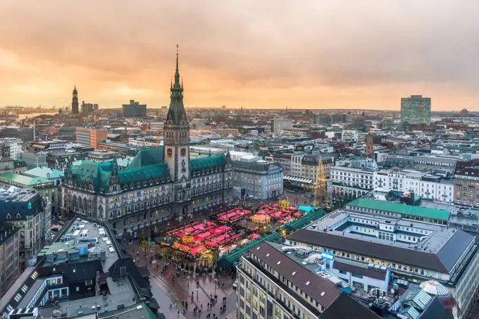 Germany, Hamburg, Christmas market at town hall in the evening