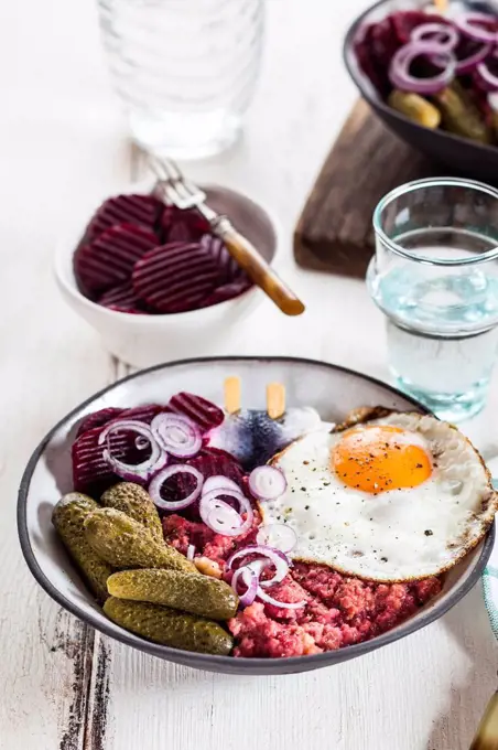 Labskaus, rollmops, pickled gherkin, beetroot salad, onion and fried egg