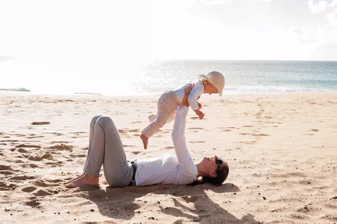 Happy mother with little daughter on the beach