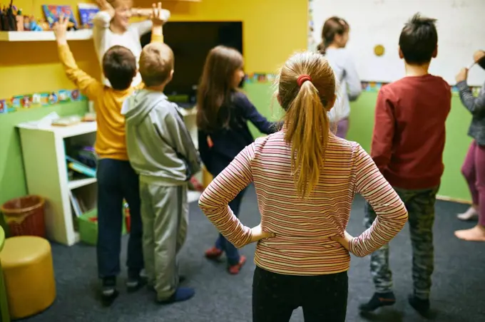 Teacher with students in relaxation room with whiteboard