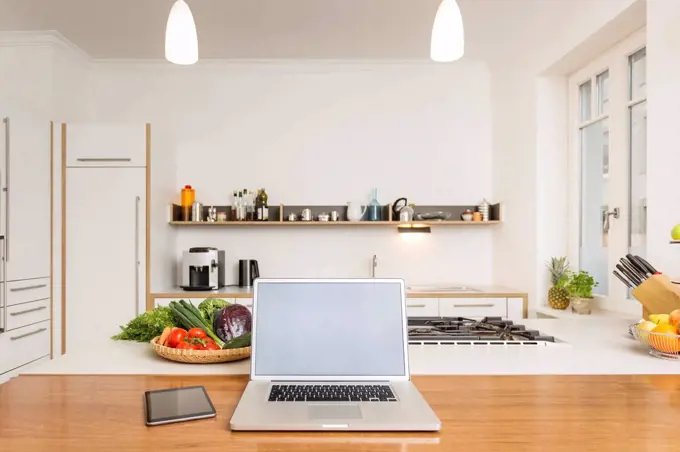 Laptop and tablet on kitchen counter