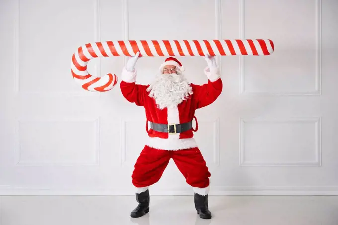 Santa Claus with oversized candy cane