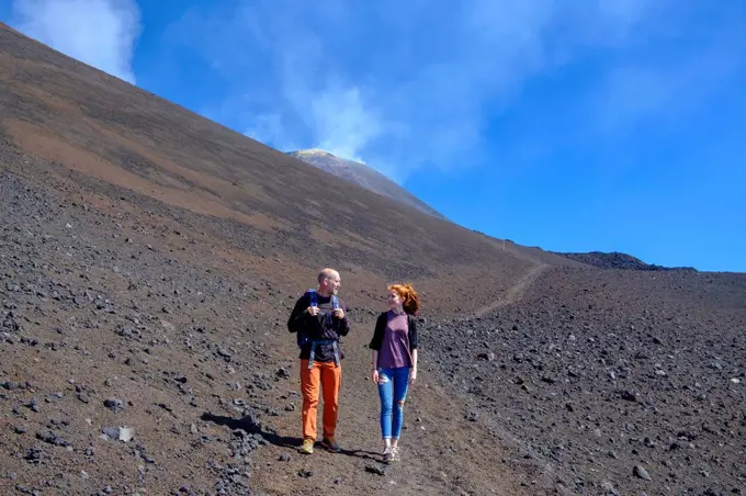 Italy, Sicily, Mount Etna, father and daughter hiking